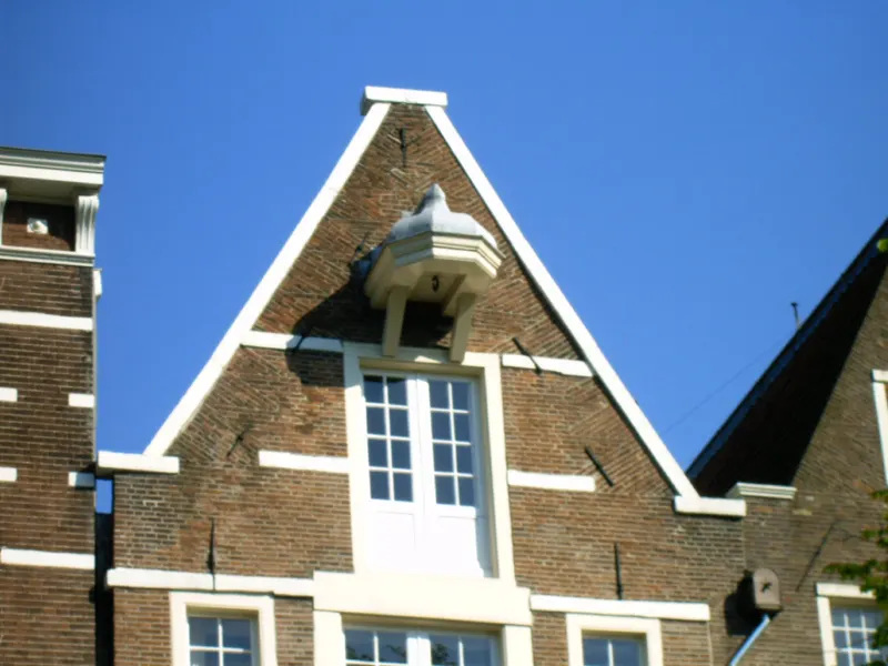 A hoisting beam with a hook at the top of an Amsterdam canal house gable